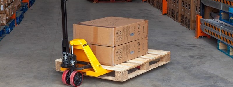 Heavy-duty Pallet Truck moving a pallet in the warehouse 