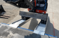 digger driving up vehicle ramps 
