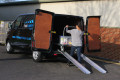 Person loading trolly using aluminium channel ramps 