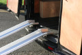 Aluminium channel ramps resting on van 