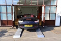 Car loading ramps in to a show room 