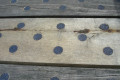 Black circular discs on wood 