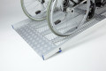 Wheelchair going up the folding van ramp 