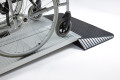 Manual wheelchair going over combination ramps 