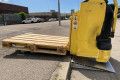 Electric pallet truck overcoming a kerb using an aluminium wedge ramp 