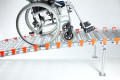 Wheelchair going up rollable ramp 