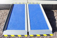 Folding wheelchair ramp resting on step 