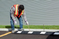 Black and white wheel block, secure to tarmac and concrete 