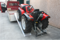 Tractor going up alloy ramps 