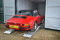 Sports car driving in to a container 