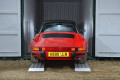 Vintage sports car driving in to a container 