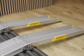 Portable wheelchair ramps used to overcome door threshold 