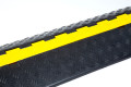 Black and yellow cable protector with chequered anti-slip surface 