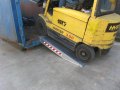 Forklift going up Container loading ramps resting on container 