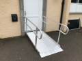 Wheelchair ramp resting on door 