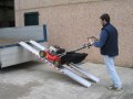 Loading lawnmower using channel ramps on to truck 