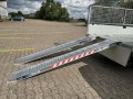 Aluminium loading ramps on trailer resting on van 
