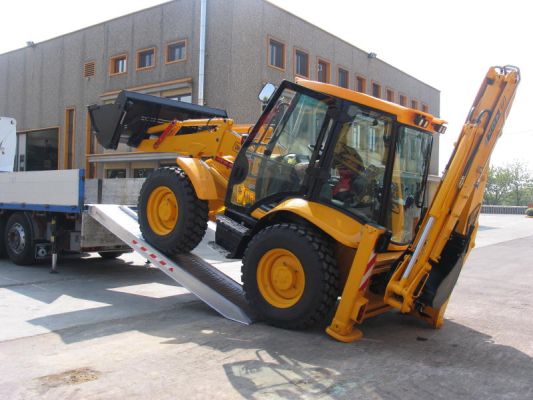Digger driving on to channel ramps 