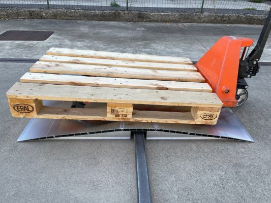 Pallet truck going over bridge ramp 