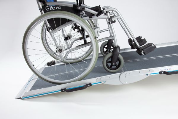 Manual wheelchair going up the wheelchair ramp 