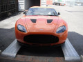 Sports car driving in to container on loading ramps 