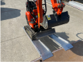 Digger driving up ramps alloy 