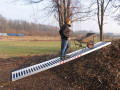 Person loading on aluminium skip ramp 