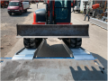 Ramps resting on the vehicle with digger driving up