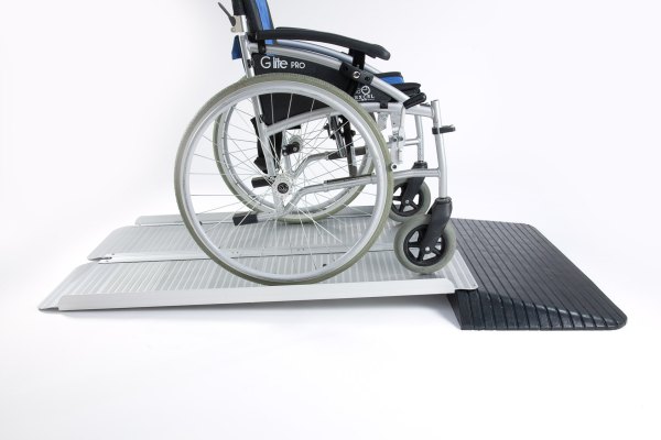 Folding wheelchair ramp on rubber threshold ramp 