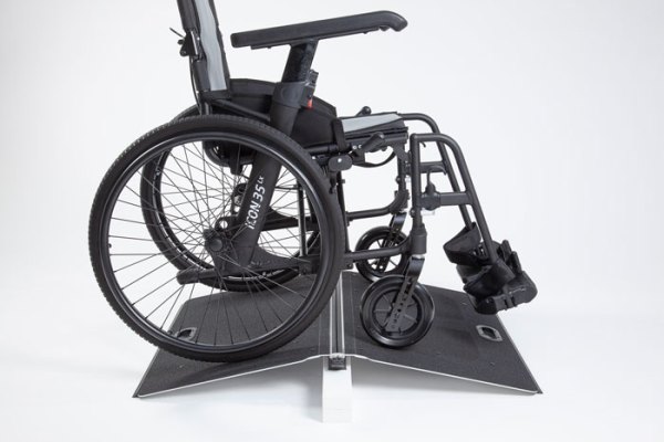 Wheelchair overcoming threshold using bridge ramp 