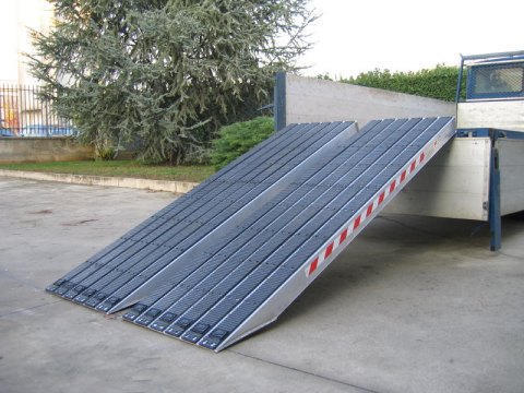 Rubber coated ramps resting on tipper truck 