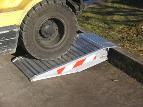  aluminium container ramps resting on a kerb 