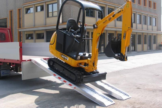Pair of aluminium plant loading ramps with a digger on 