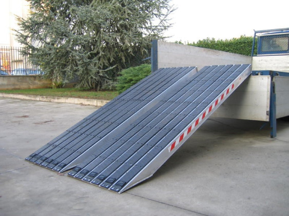 Rubber coated channel ramps resting on vehicle 