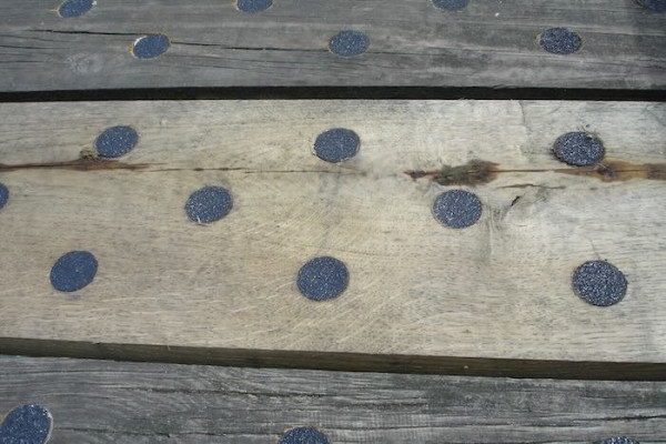 Black discs on timber