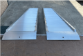 Ramps resting on flat bed vehicle 