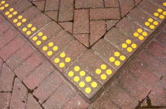 Yellow discs on pavement 