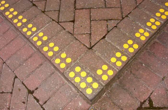 Yellow discs on pavement 