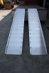 Pair of alloy ramps resting on vehicle 