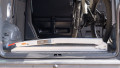 Motorbike loading ramp folded up and stored in boot