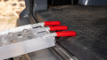 Pair of motorbike loading ramps resting on vehicle boot, close up of rest on connection