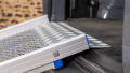 Close up of the rest on connection of a FEAL folding van ramp resting on boot of car