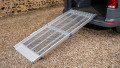 FEAL folding van ramp resting in place on the boot of a car