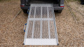 FEAL folding van ramp resting in place on the boot of a car
