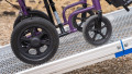 Manual wheelchair going up FEAL AnyRamp into a vehicle