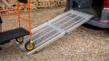 Trolley being pushed up a anyramp loading ramp during loading 