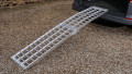 Single extra wide motorcycle ramp resting in place on the boot of a vehicle