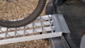 Push bike being pushed up our extra wide motorcycle loading ramps