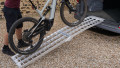 Push bike being pushed up our single extra wide motorcycle loading ramp