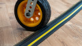 a trolly going over a single channel black and yellow cable protector